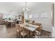 Inviting dining room showcasing modern lighting, wood floors, and an adjacent open-concept kitchen at 112 Stonewater Dr # 33P, Red Cross, NC 28129