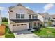 Attractive two-story home with a two-car garage and manicured lawn on a sunny day at 112 Stonewater Dr # 33P, Red Cross, NC 28129