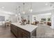 Open-concept kitchen with large island, pendant lighting, and seamless flow to the dining and living areas at 112 Stonewater Dr # 33P, Red Cross, NC 28129