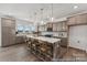 Well-lit kitchen with an expansive island, modern cabinetry, stainless steel appliances, and hardwood floors at 112 Stonewater Dr # 33P, Red Cross, NC 28129