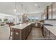 Spacious kitchen featuring a large center island, modern pendant lighting, and stainless steel appliances at 112 Stonewater Dr # 33P, Red Cross, NC 28129