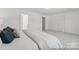 Main bedroom with neutral walls, carpeted floors, and a king bed with hallway access at 112 Stonewater Dr # 33P, Red Cross, NC 28129