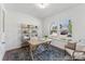 Bright home office featuring natural light from large windows, rustic desk, and decorative shelving at 112 Stonewater Dr # 33P, Red Cross, NC 28129