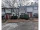 View of townhouse complex with muted exterior, red doors, and well-maintained landscaping at 115 Eastcliff Se Dr # 4, Concord, NC 28025
