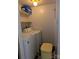 Compact laundry area featuring a washer, dryer, and shelving for storage at 115 Eastcliff Se Dr # 4, Concord, NC 28025