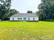 Exterior rear view showcasing a well-maintained lawn, and charming home with white siding at 120 Random Dr, Salisbury, NC 28147