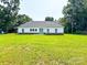 Exterior rear view showcasing a well-maintained lawn, and charming home with white siding at 120 Random Dr, Salisbury, NC 28147