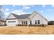 Attractive home exterior showcasing white siding, brick accents, and a welcoming entrance at 120 Random Dr, Salisbury, NC 28147