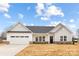 Charming single-story home with a two-car garage, a well-manicured lawn, and a welcoming front porch at 120 Random Dr, Salisbury, NC 28147