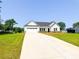 Charming single-story home boasting a well-manicured lawn, a two-car garage and long driveway at 120 Random Dr, Salisbury, NC 28147