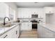 Modern kitchen featuring white cabinetry, stainless steel appliances, granite countertops, and an island with seating at 120 Random Dr, Salisbury, NC 28147