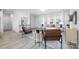 Bright living room with neutral walls, modern furniture, and large windows, and light gray plank floors at 120 Random Dr, Salisbury, NC 28147