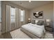 Well-lit bedroom with neutral paint, carpet, and two windows draped with stylish floor-length white curtains at 139 Aberdeen Dr, Salisbury, NC 28144