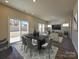 Open dining space featuring a sliding glass door to the backyard and connecting to a cozy living area at 139 Aberdeen Dr, Salisbury, NC 28144