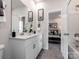 Well-lit bathroom with double sinks, white cabinets, and modern fixtures at 1401 Windy Park Dr, Stanley, NC 28164
