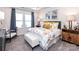 Inviting main bedroom with plush carpeting, large windows, and stylish furniture at 1401 Windy Park Dr, Stanley, NC 28164