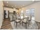Open-concept dining area with modern table, chairs, and adjacent to a bright kitchen at 151 Aberdeen Dr, Salisbury, NC 28144