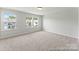 Spacious bedroom with neutral carpet and ample natural light from two large windows overlooking the neighborhood at 162 Mooring Dr # 341P, Statesville, NC 28677