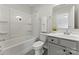 Bright bathroom featuring a shower-tub combo, gray vanity with white countertop, and neutral wall paint at 163 Stonewater Dr # 4P, Red Cross, NC 28129