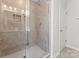 Bathroom with glass enclosed shower stall and tiled walls, and a door to the rest of the home at 163 Stonewater Dr # 4P, Red Cross, NC 28129