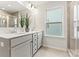Bathroom with dual sinks, a large mirror, decorative plant, and a window for plenty of natural light at 163 Stonewater Dr # 4P, Red Cross, NC 28129