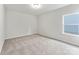 A cozy bedroom with neutral carpeting, light walls, and a window providing natural light at 163 Stonewater Dr # 4P, Red Cross, NC 28129