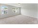 Bright bedroom featuring plush carpeting, neutral walls, and natural light from double windows at 163 Stonewater Dr # 4P, Red Cross, NC 28129