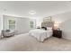 Comfortable main bedroom featuring a large bed, soft carpet, and natural light from the windows at 163 Stonewater Dr # 4P, Red Cross, NC 28129
