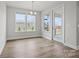 Bright dining area featuring wood floors, natural light from windows, and a glass door leading to an outdoor space at 1726 Riverbend Ave # 177, Belmont, NC 28012