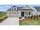 Charming single-Gathering home featuring a two-car garage, manicured lawn, and inviting front porch at 1726 Riverbend Ave # 177, Belmont, NC 28012