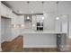 Modern kitchen with white cabinets, subway tile backsplash, and a spacious center island at 1726 Riverbend Ave # 177, Belmont, NC 28012