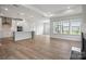 Open-concept living room with hardwood floors, recessed lighting, and large windows at 1726 Riverbend Ave # 177, Belmont, NC 28012