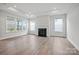 Bright living room featuring a modern fireplace, hardwood floors, and multiple windows at 1726 Riverbend Ave # 177, Belmont, NC 28012