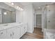 An elegant bathroom featuring double sinks, quartz countertops, and a glass shower with tile walls at 1726 Riverbend Ave # 177, Belmont, NC 28012