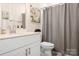 Well-lit bathroom featuring modern vanity, quartz countertop, and shower at 1903 Lotus Ln, Denver, NC 28037