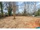 Spacious, cleared backyard ready for landscaping or outdoor activities, surrounded by mature trees at 228 Chestnut St # 66, Shelby, NC 28150