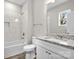 Clean bathroom with granite countertop, white cabinets, and tiled shower at 228 Chestnut St # 66, Shelby, NC 28150