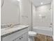 Bright bathroom with granite countertop, white cabinets, and tiled shower at 228 Chestnut St # 66, Shelby, NC 28150