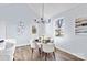 Bright dining area features modern lighting and decor, a glass-topped table, and views of the yard at 228 Chestnut St # 66, Shelby, NC 28150