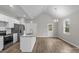 Open-concept kitchen with stainless appliances, an island with bar, white cabinetry, and an eat-in area at 228 Chestnut St # 66, Shelby, NC 28150