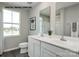 Bright bathroom with a double vanity, white cabinetry, framed mirror, and tile flooring at 256 Basildon St # 1045, Lancaster, SC 29720