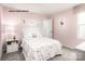 Cozy pink bedroom with comfortable decor and plenty of natural light at 320 Basildon St # 1076, Lancaster, SC 29720