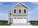 Charming two-story home with a gray exterior and white garage door at 320 Basildon St # 1076, Lancaster, SC 29720