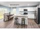 Well-lit kitchen with stainless steel appliances, center island, and dining area at 320 Basildon St # 1076, Lancaster, SC 29720