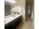 Bathroom featuring a dark vanity with white countertops, mirror and a tiled floor at 359 Magness Rd, Shelby, NC 28150