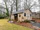 Charming backyard shed with unique details, including a clock and decorative signs at 3642 Litchfield Rd, Charlotte, NC 28211