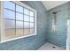 Elegant walk-in shower featuring large window, bronze hardware and blue tiling at 4630 Hannah Dr, Rock Hill, SC 29732