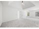 Spacious main bedroom featuring tray ceiling, neutral carpet, and natural light through windows at 4630 Hannah Dr, Rock Hill, SC 29732