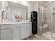 This modern bathroom has a double vanity with a glass enclosed shower with seating at 5006 Kellaher Pl, Charlotte, NC 28216