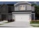 Charming townhome exterior showcasing a two-car garage, gray siding, and well-maintained landscaping at 5006 Kellaher Pl, Charlotte, NC 28216